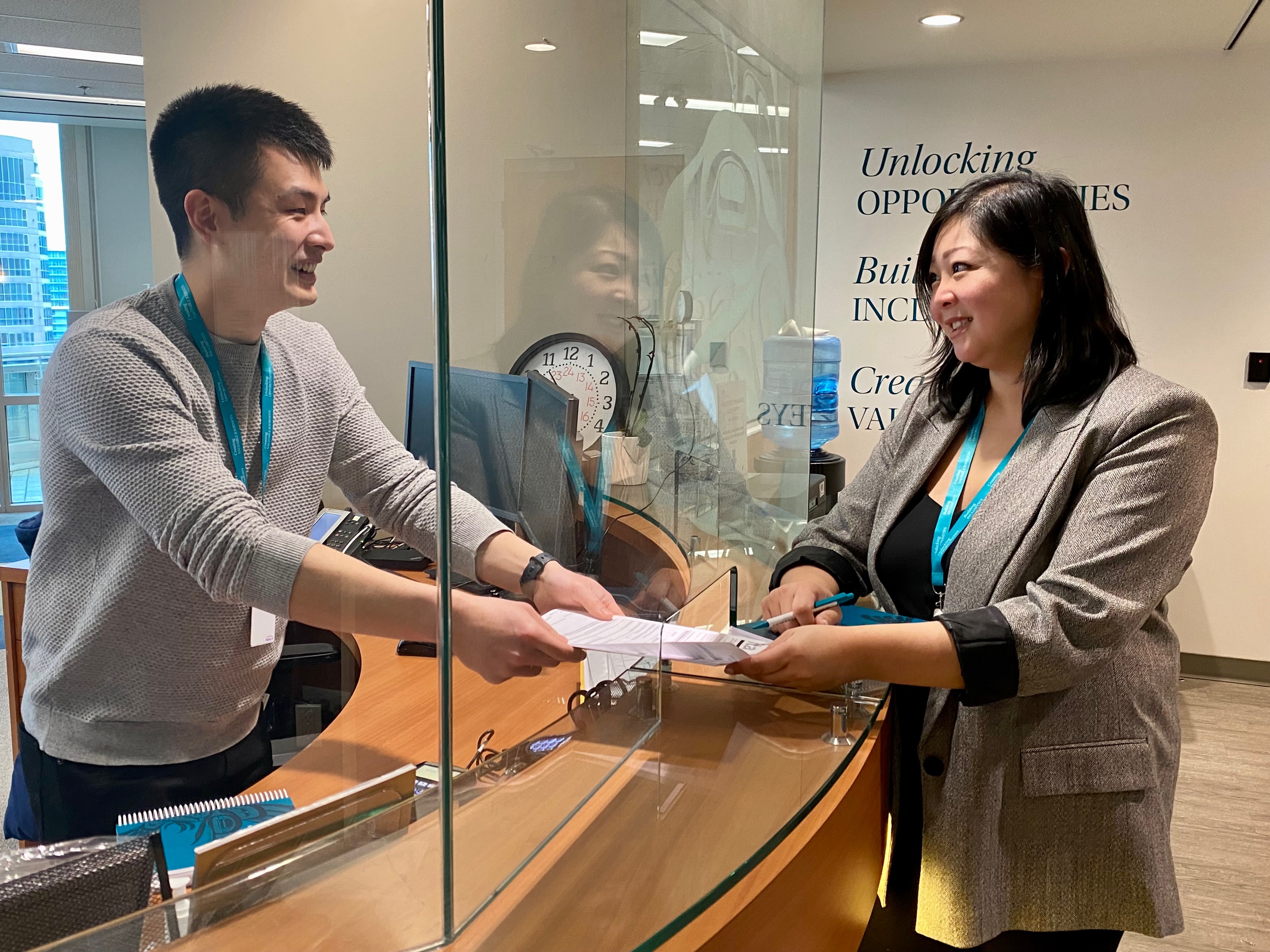 two staff members at reception desk