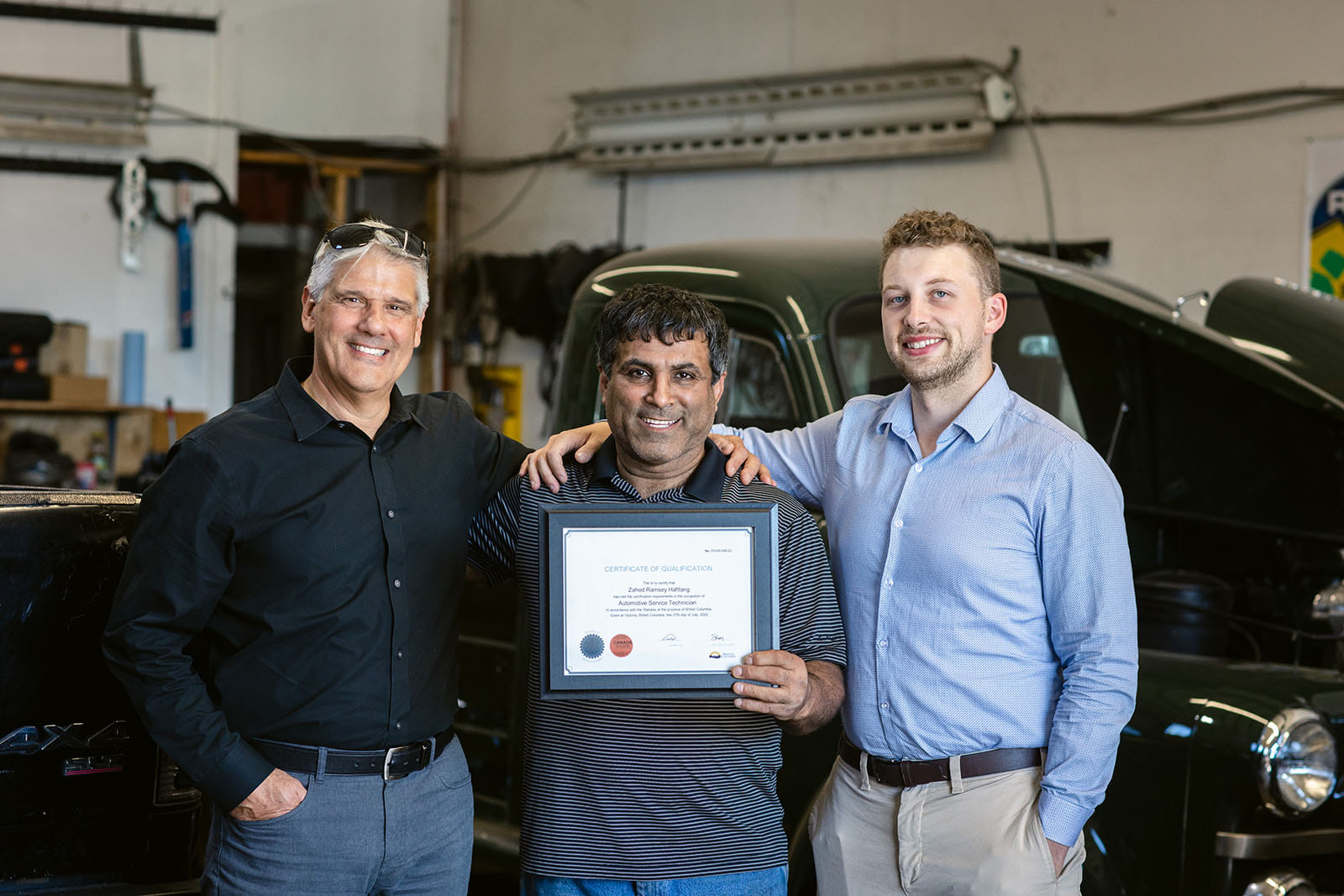 SkilledTradesBC staff with newly certified Red Seal auto service technician