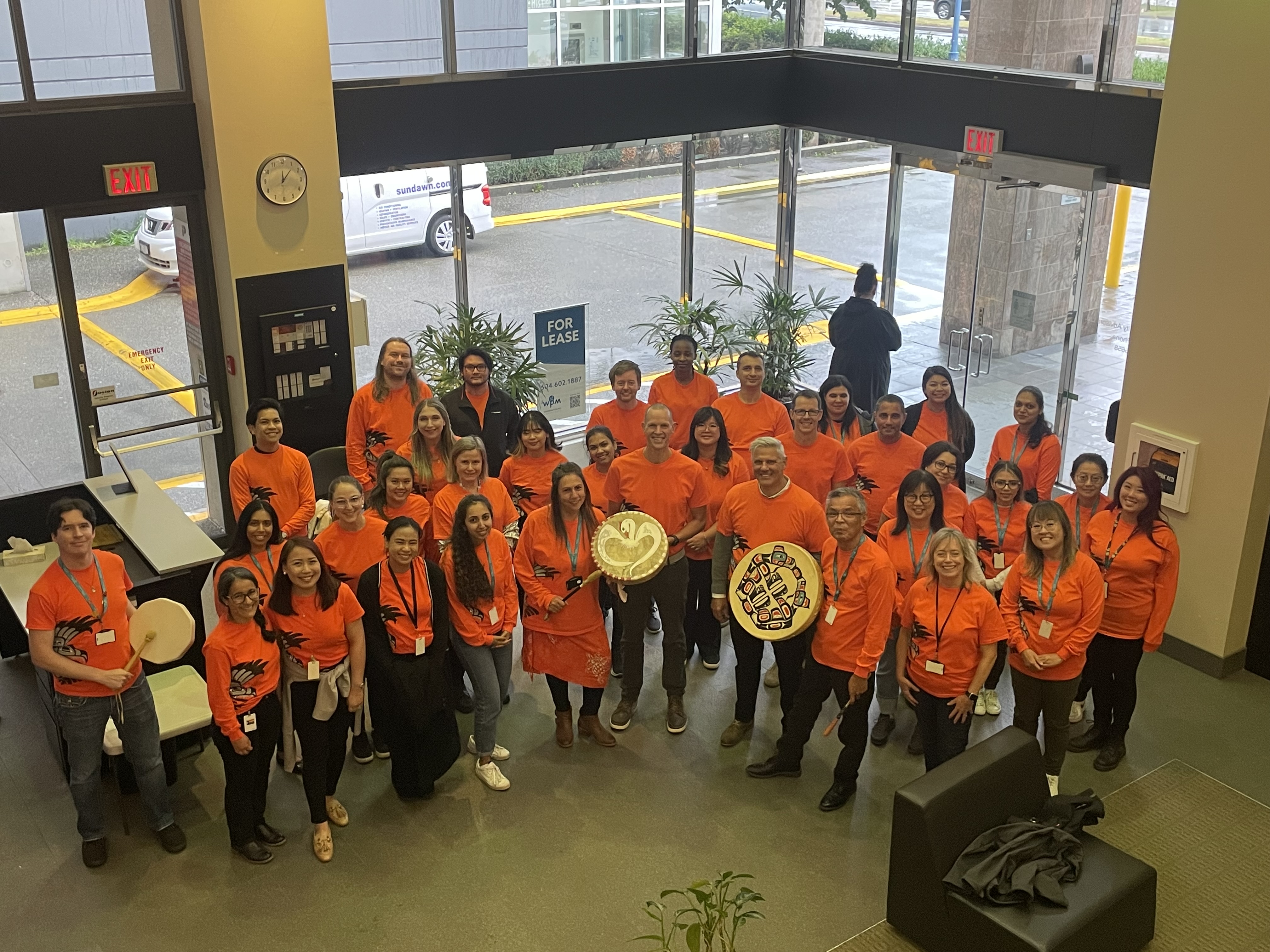 Staff in lobby wearing orange shirts