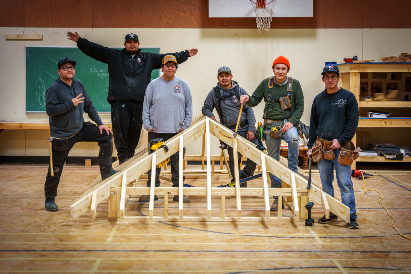 Carpenters in front of wooden structure