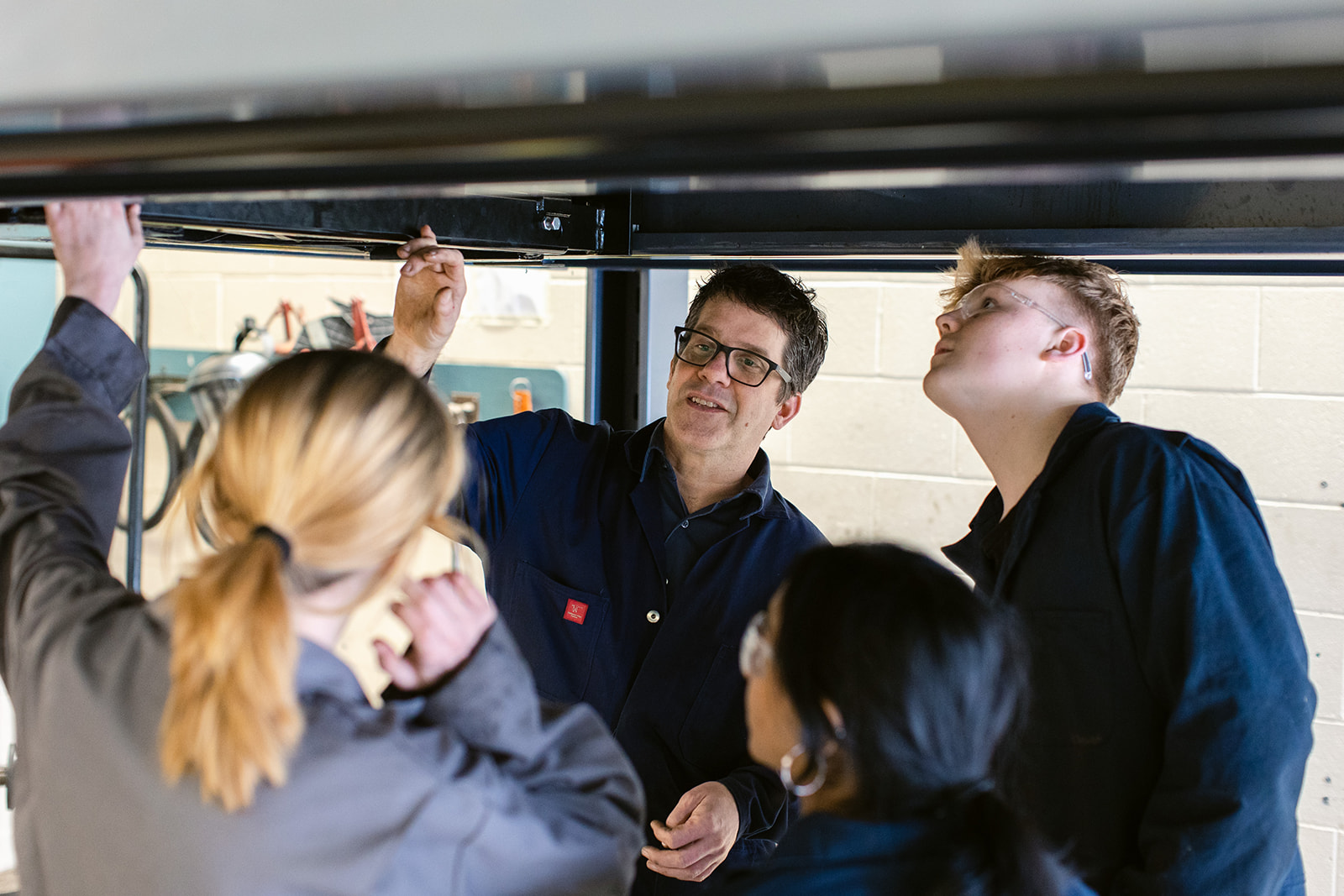 instructor teaching automotive students