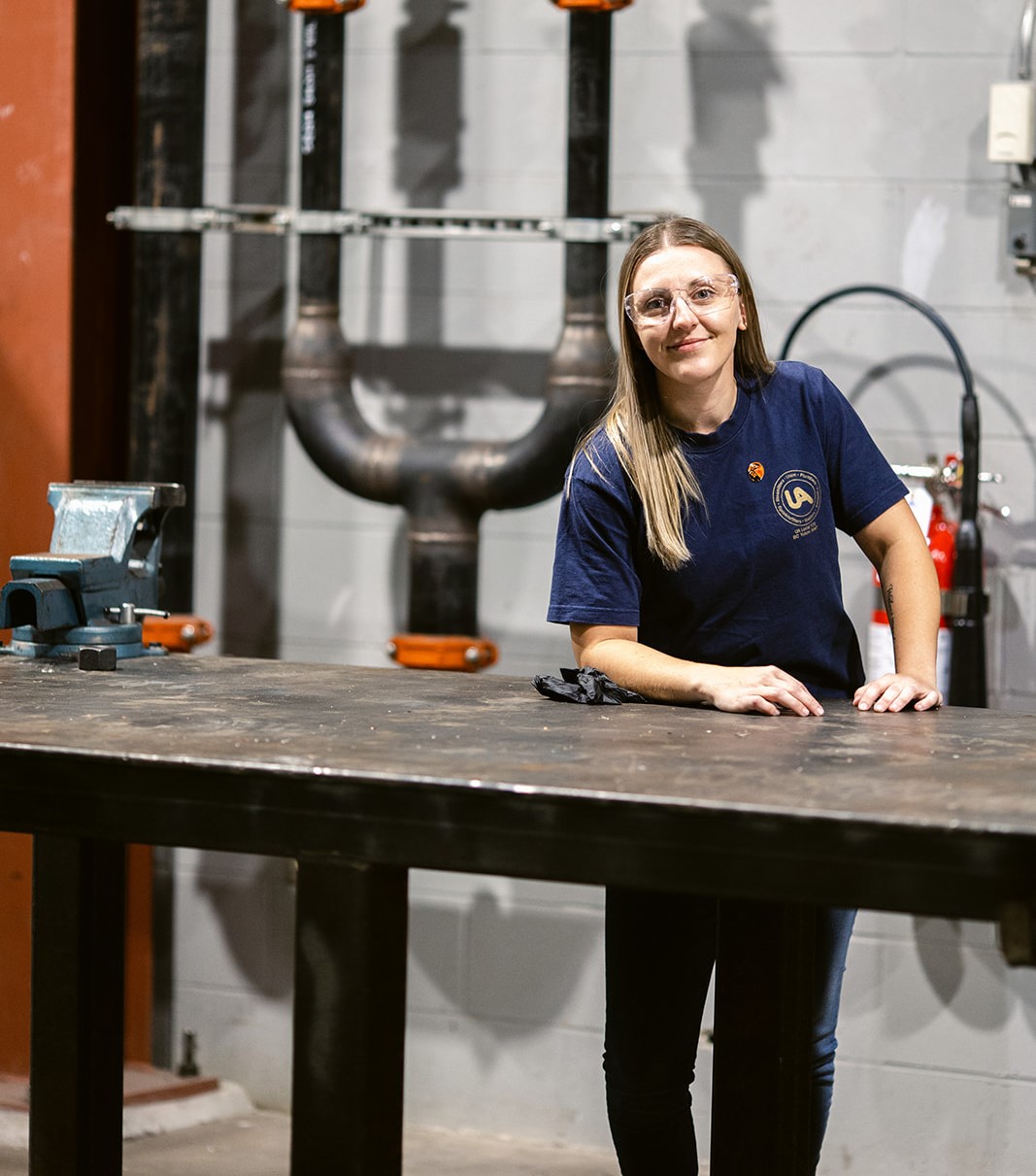 pipefitter woman standing by table