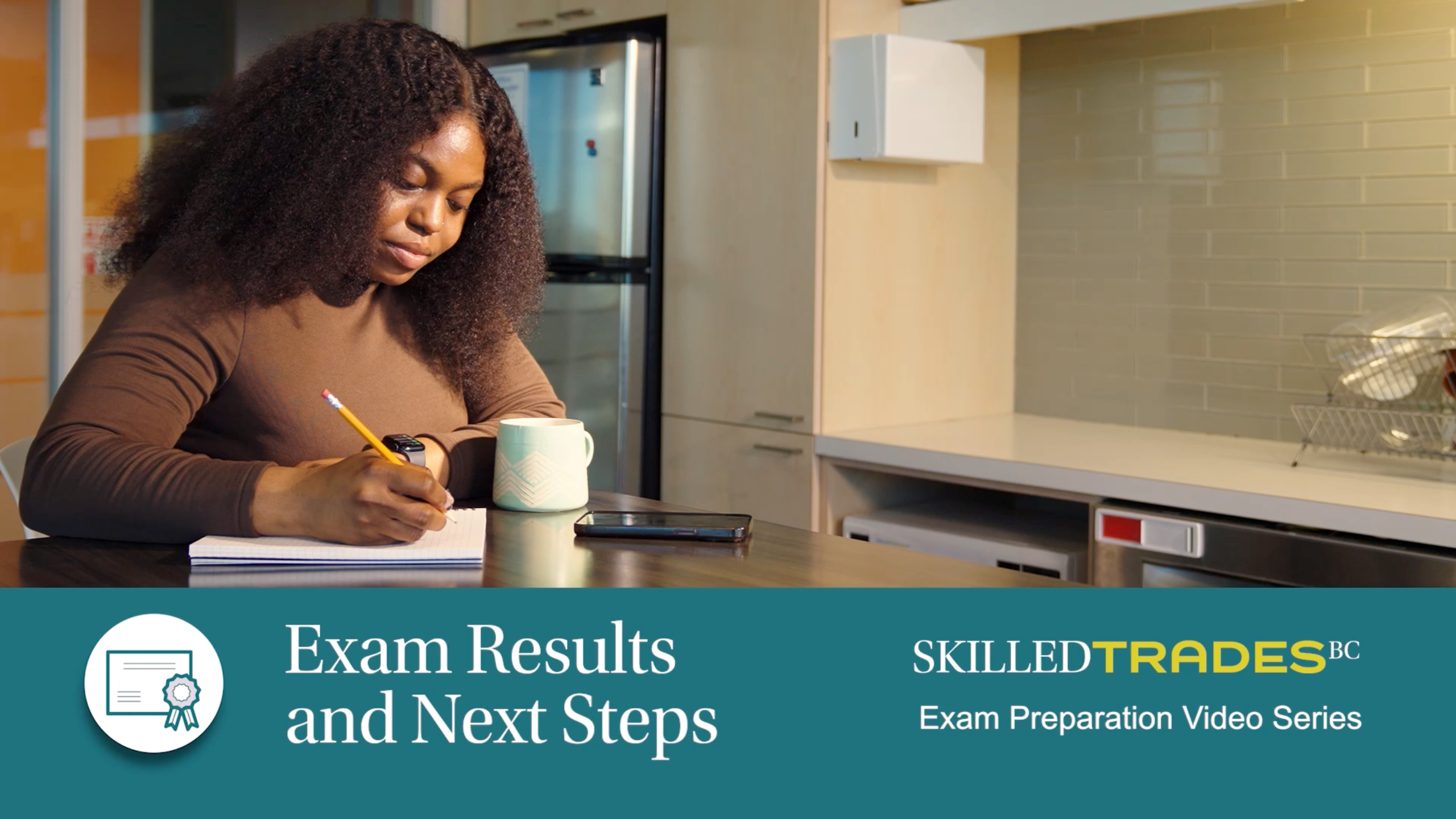 Woman on her phone with mug in background on table