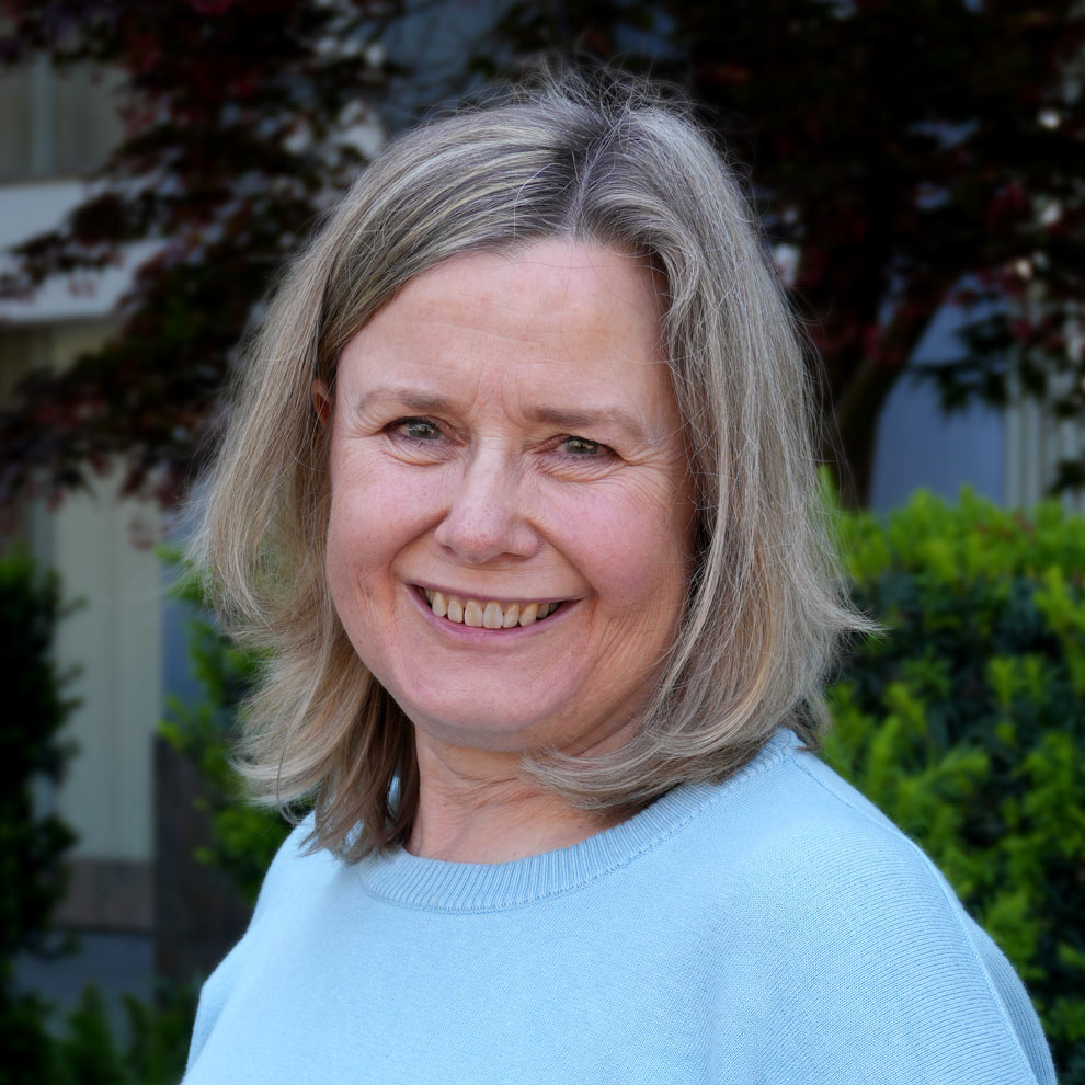 woman portrait with short blonde hair and blue top