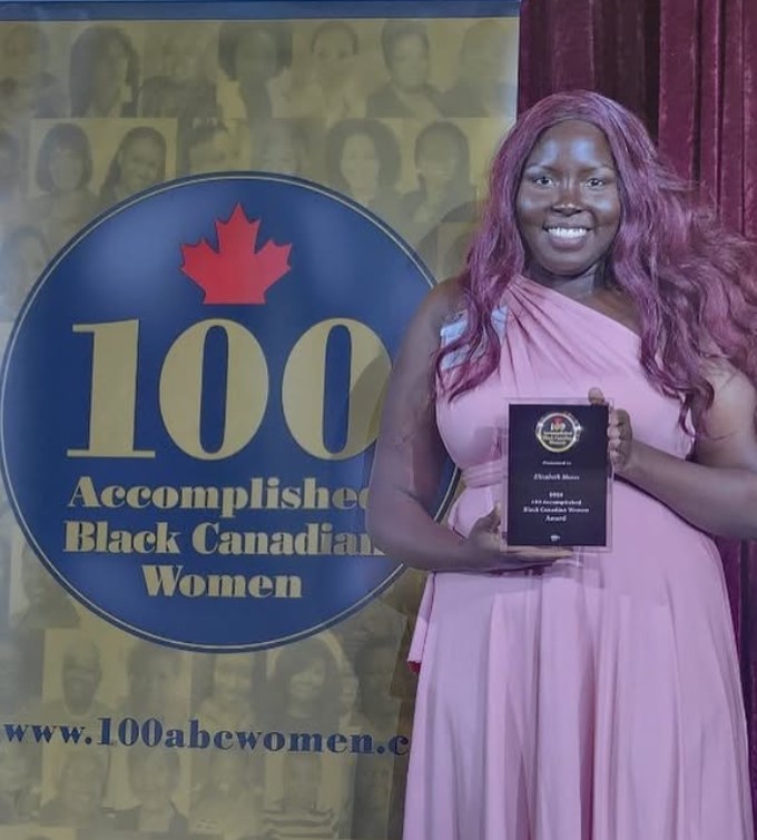 Elizabeth Moses posing with her award, named as one of ABC women's Top 100 Accomplished Black Canadian Women