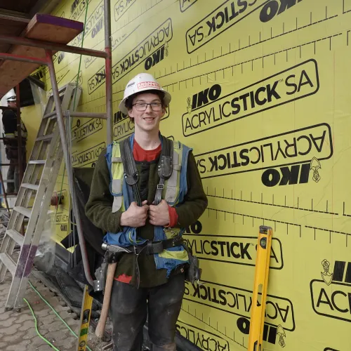 Ethan standing in front of building under construction