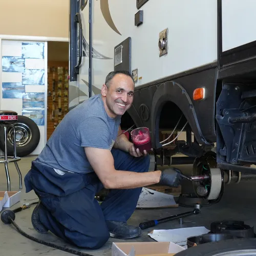 RV service technician working on a vehicle