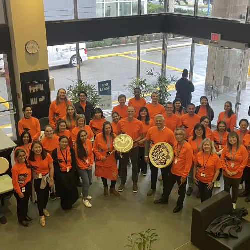 Staff in lobby wearing orange shirts