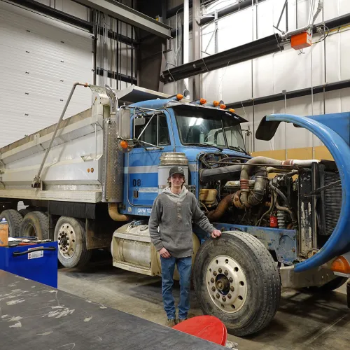 Ryan standing in front of heavy duty machine
