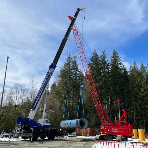 mobile crane on the ground with forest in the background
